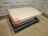 a stack of mattresses on a pallet in front of a wall