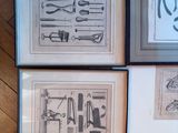 four framed prints of various tools displayed on a wooden floor