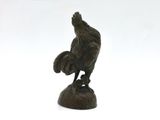 a statue of a bird on a rock on a white background