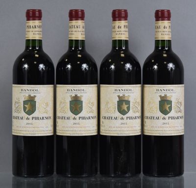 four bottles of wine are lined up on a table