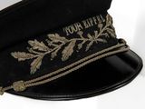 a black hat with a gold embroidered design on it