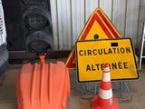 a traffic sign and a traffic cone sitting next to each other