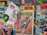 a person holding a comic book in front of a bunch of comics