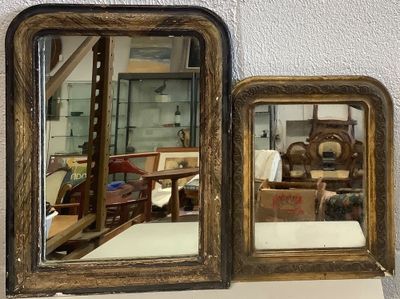 two mirrors that are on the wall next to each other