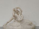a statue of a woman sitting on top of a table