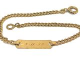 an image of a gold plated bracelet with a chain attached to it