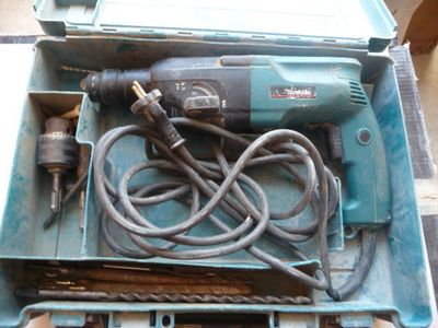 a blue tool box with tools in it on a table