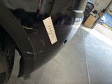a close up of a black car with a tag on it
