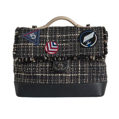 this image may contain a handbag or a purse with patches on it
