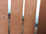 a close up of a wooden bench with a sign on it