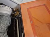 an orange cabinet that has a hose in it