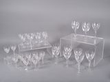 many wine glasses on a clear shelf on a white background