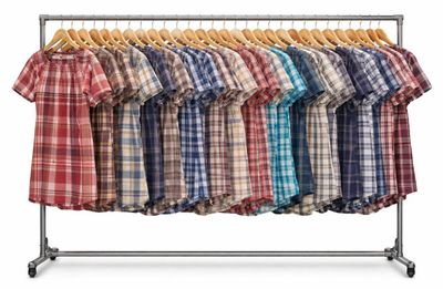 clothes hanging on a clothes rack on a white background