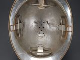an image of a metal helmet with a hole in the middle