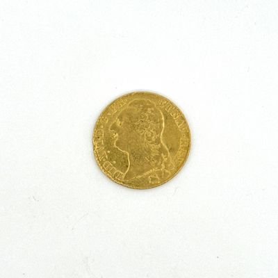 une pièce d'or sur laquelle figure l'image d'un homme