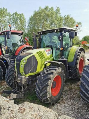 three tractors parked next to each other on the side of the road