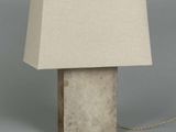 concrete table lamp with a linen shade on a grey background