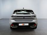 the rear end of a silver car in a white room