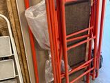 a red ladder with a sign on it in a room