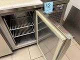 a stainless steel refrigerator with a door open in a kitchen