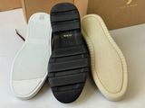 three pairs of white and black slippers sitting on top of a table