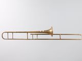 a brass trombone with a white background