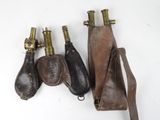 trois bouteilles de vin anciennes plaquées laiton et un étui en cuir