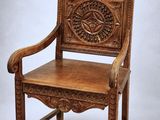 an old wooden chair with a carved back and seat on a white background