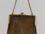 un sac à main marron avec une chaîne qui pend sur le côté