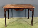 an old wooden table with a small drawer on top of it