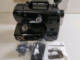 an image of a black sewing machine sitting on top of a table