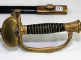 a sword that is sitting on a table next to a knife