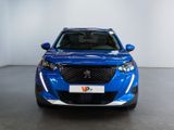 the front view of a blue suv parked in a garage