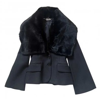 the jacket is black and has a fur collar on it