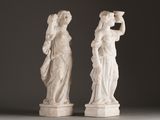 pair of white marble statues of a woman and a man