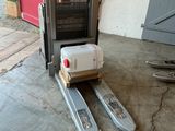 a fork lifter with a box on it in a garage