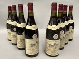 six bottles of wine are lined up in a row on a table