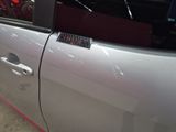 a close up of a car door with a sticker on it