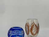 pair of blue and white glass vases sitting on a white surface