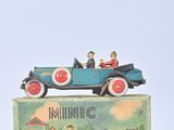 a toy car with people in it sitting on top of a box
