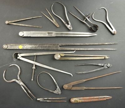 many different types of scissors and pliers on the table