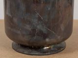 a large metal pot sitting on top of a wooden table