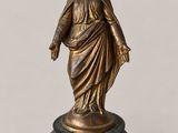 a bronze statue of a woman with a veil on her head