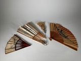 several wooden fans are arranged on a white surface