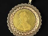 a close up of a gold coin on a black background