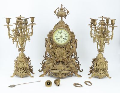 a clock that is sitting next to a bunch of candles
