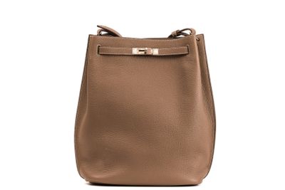 a brown leather handbag with a gold metal handle