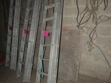 several ladders leaning against a wall in a room