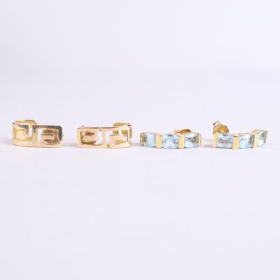 three pairs of gold and blue stone stud earrings