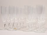 four clear wine glasses sitting on top of a white table